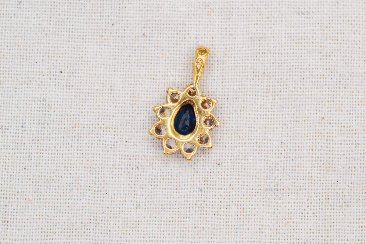 pendentif-marguerite-en-or-jaune-18-carats-orne-en son-centre-d-un-saphir-taille-en-poire-dans-un-entourage-d-oxydes-pendentif-eco-responsable