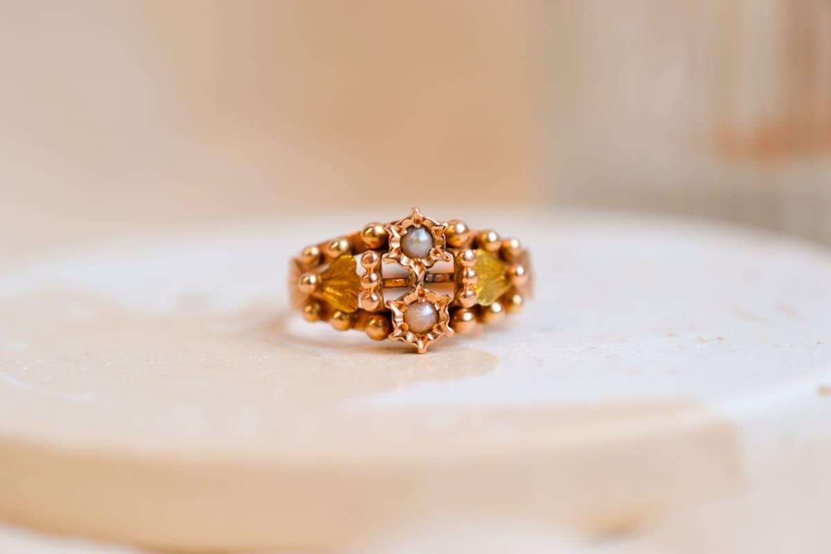 Bague Art Nouveau en Or rose 18 carats sertie de Perles dans un décor de fleur épaulées par des noeuds en Or vert entourés de billes d'Or